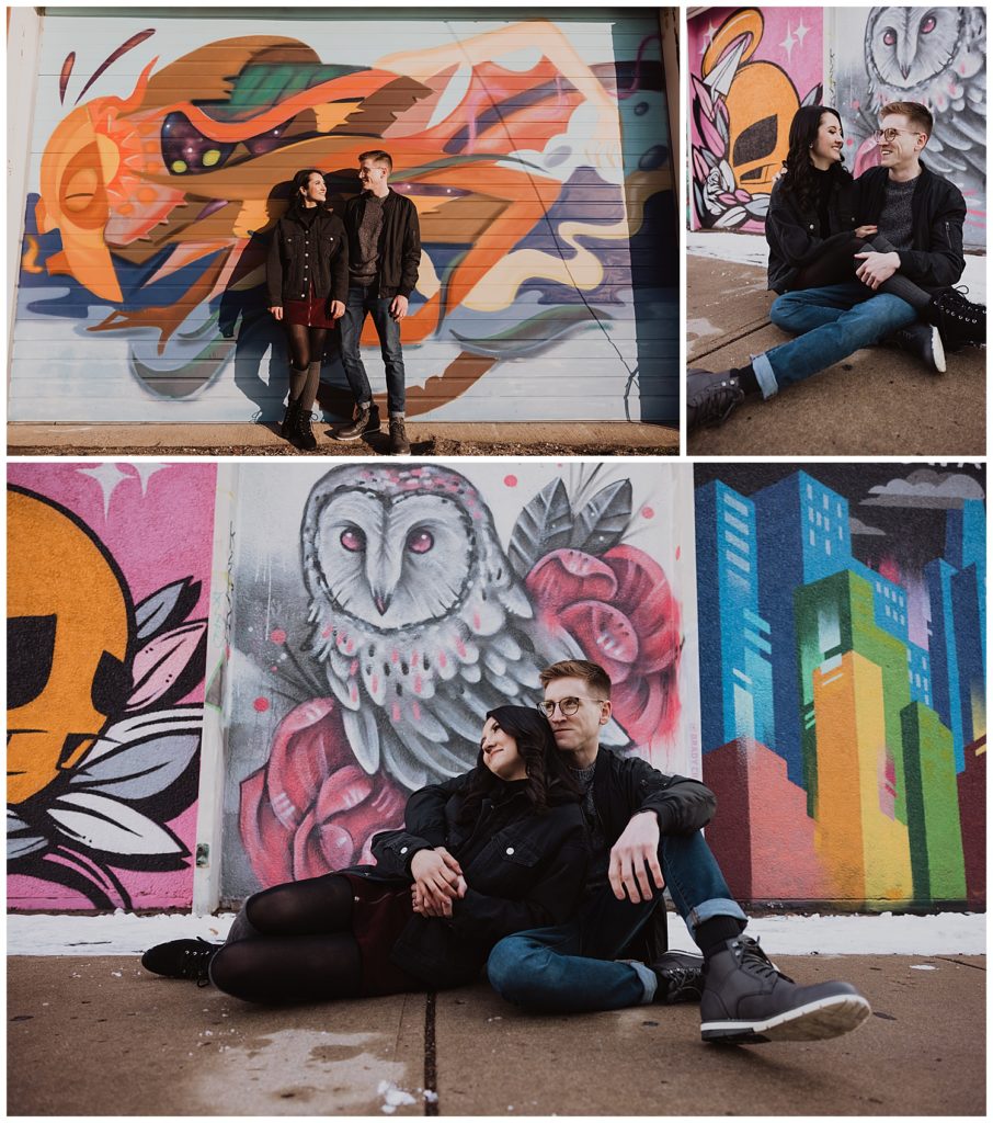 engaged couple in downtown Kansas City standing in front of a wall of murals KC murals engagement session