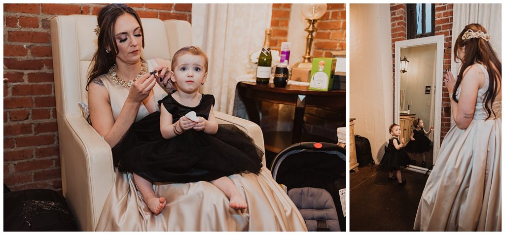 bride getting her daughter ready to be the flower girl at her wedding